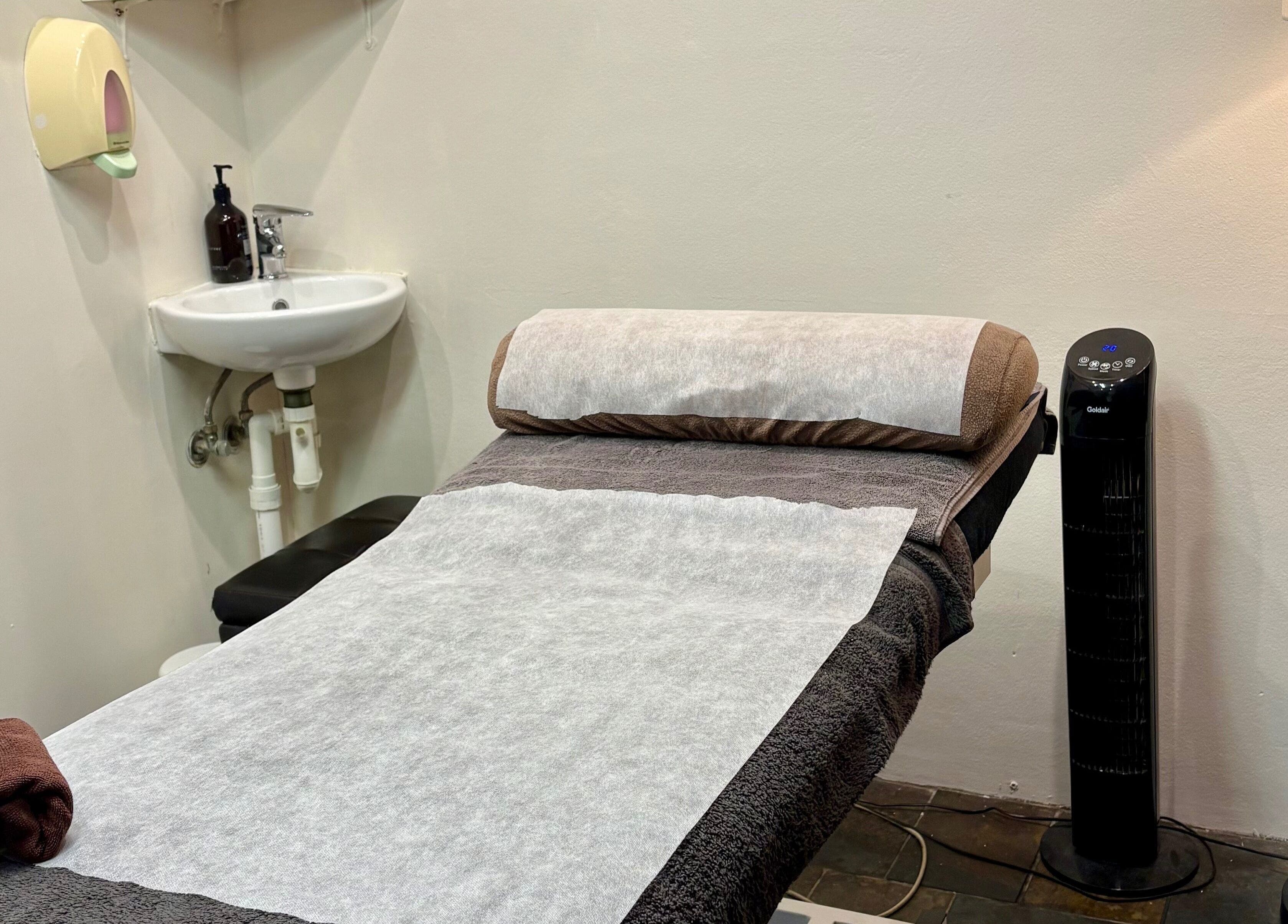 Relaxing treatment room at Smooth by Sophie, Milsons Point, NSW with a cozy massage table.