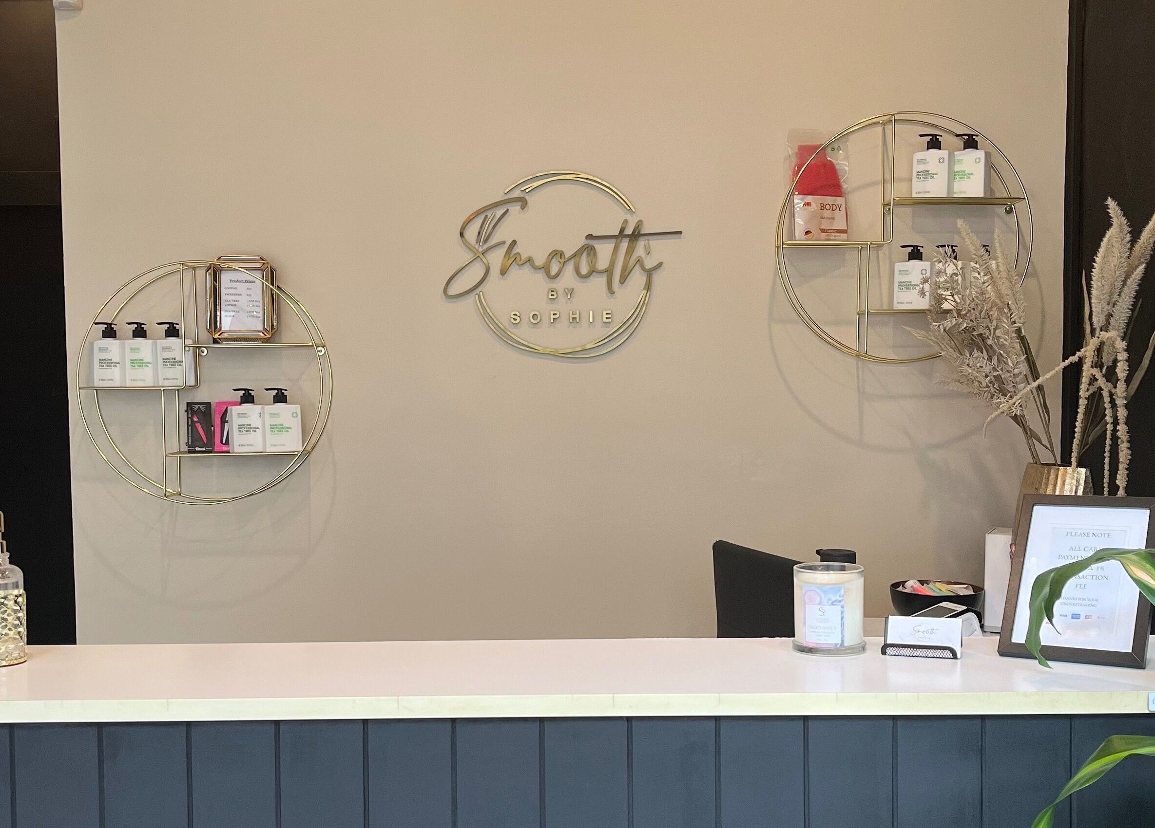 Reception desk at Smooth by Sophie, Milsons Point, New South Wales, AU, showcasing beauty products and decor.