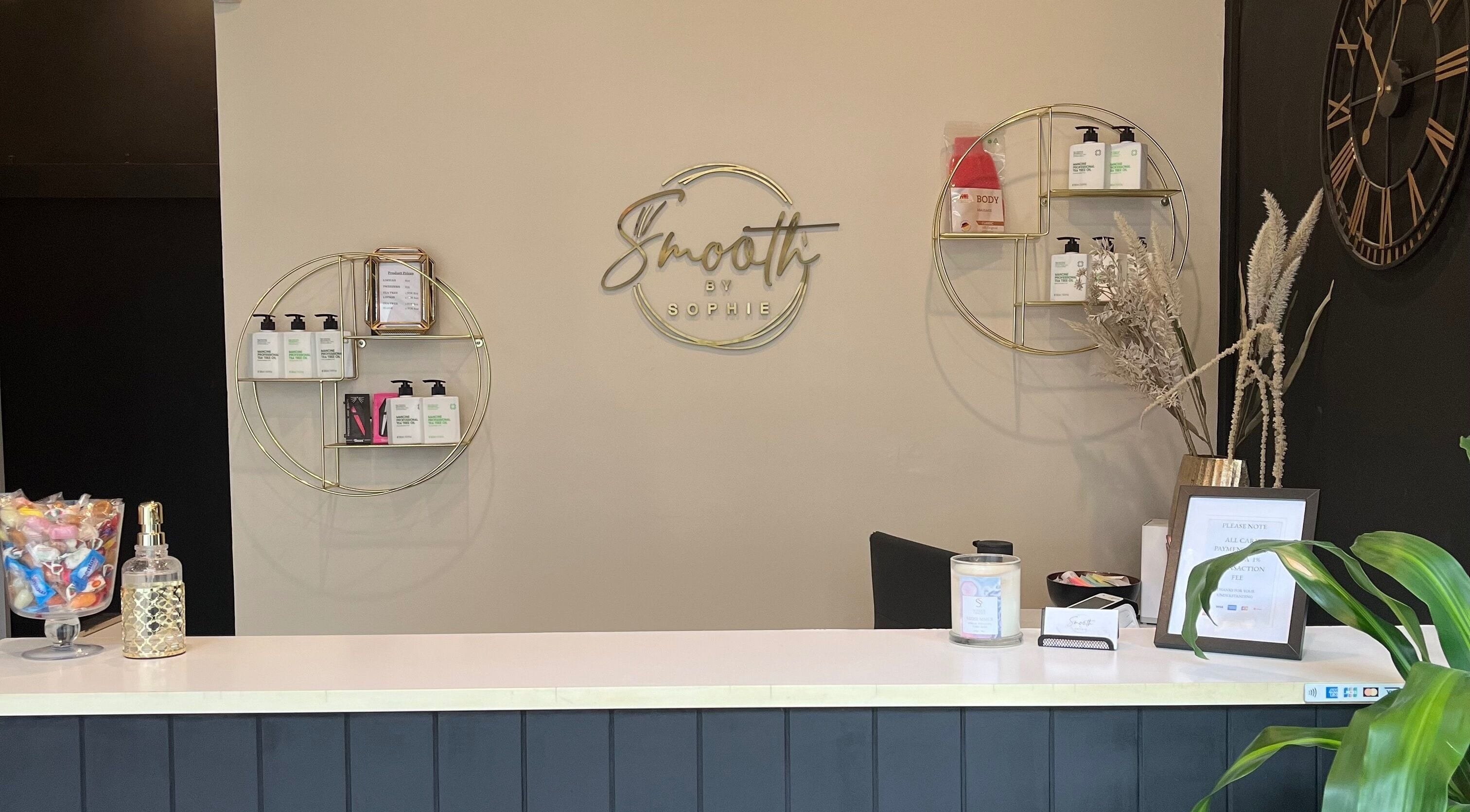 Reception desk at Smooth by Sophie, Milsons Point, New South Wales, AU, showcasing beauty products and decor.