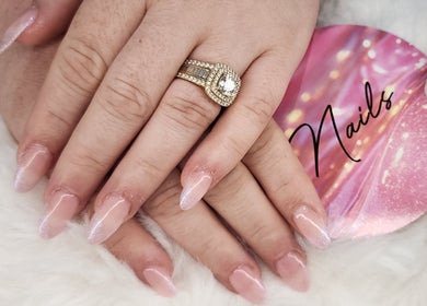 Close-up of elegant glitter nails with a ring at Twinkle_beauty_bar, Eglinton, Western Australia, AU.