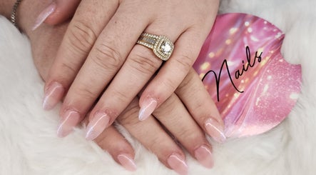 Close-up of elegant glitter nails with a ring at Twinkle_beauty_bar, Eglinton, Western Australia, AU.