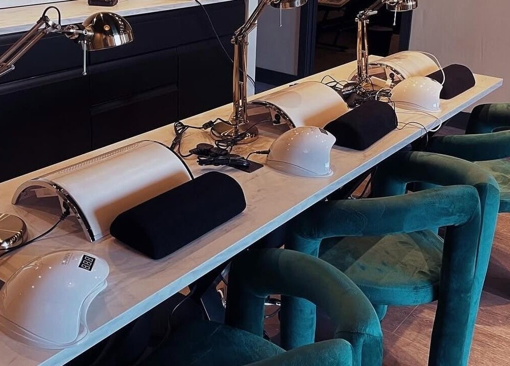 Modern nail station setup at Mono, Hoyland, England, GB, featuring sleek manicure tools and plush chairs.