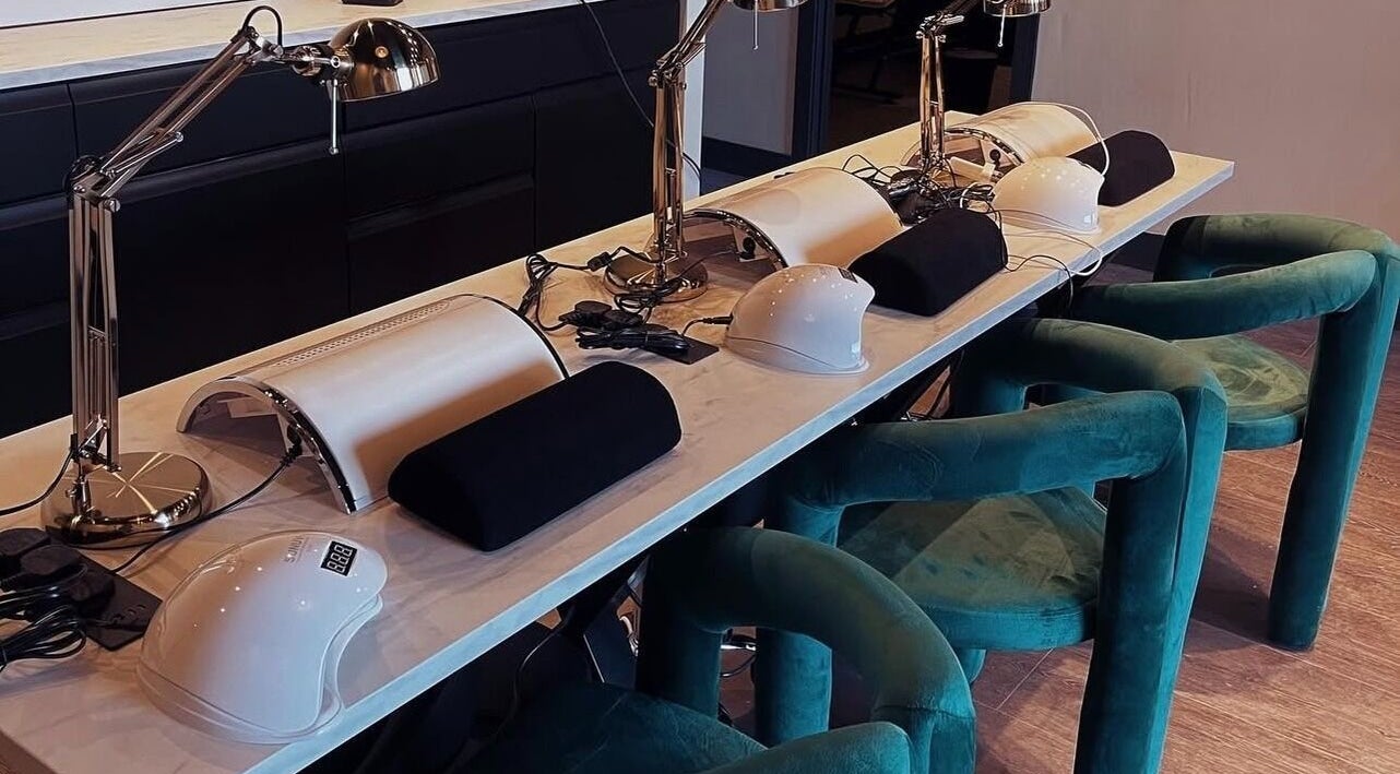 Modern nail station setup at Mono, Hoyland, England, GB, featuring sleek manicure tools and plush chairs.