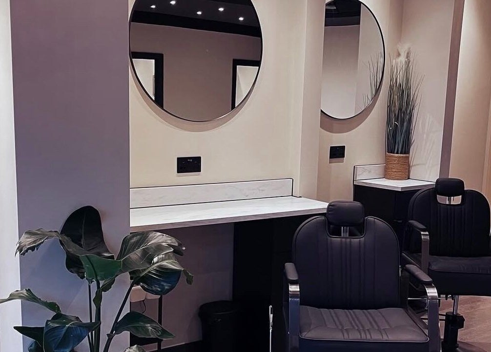 Elegant salon chairs and mirror setup at Mono, Hoyland, England, GB showcasing modern beauty venue.