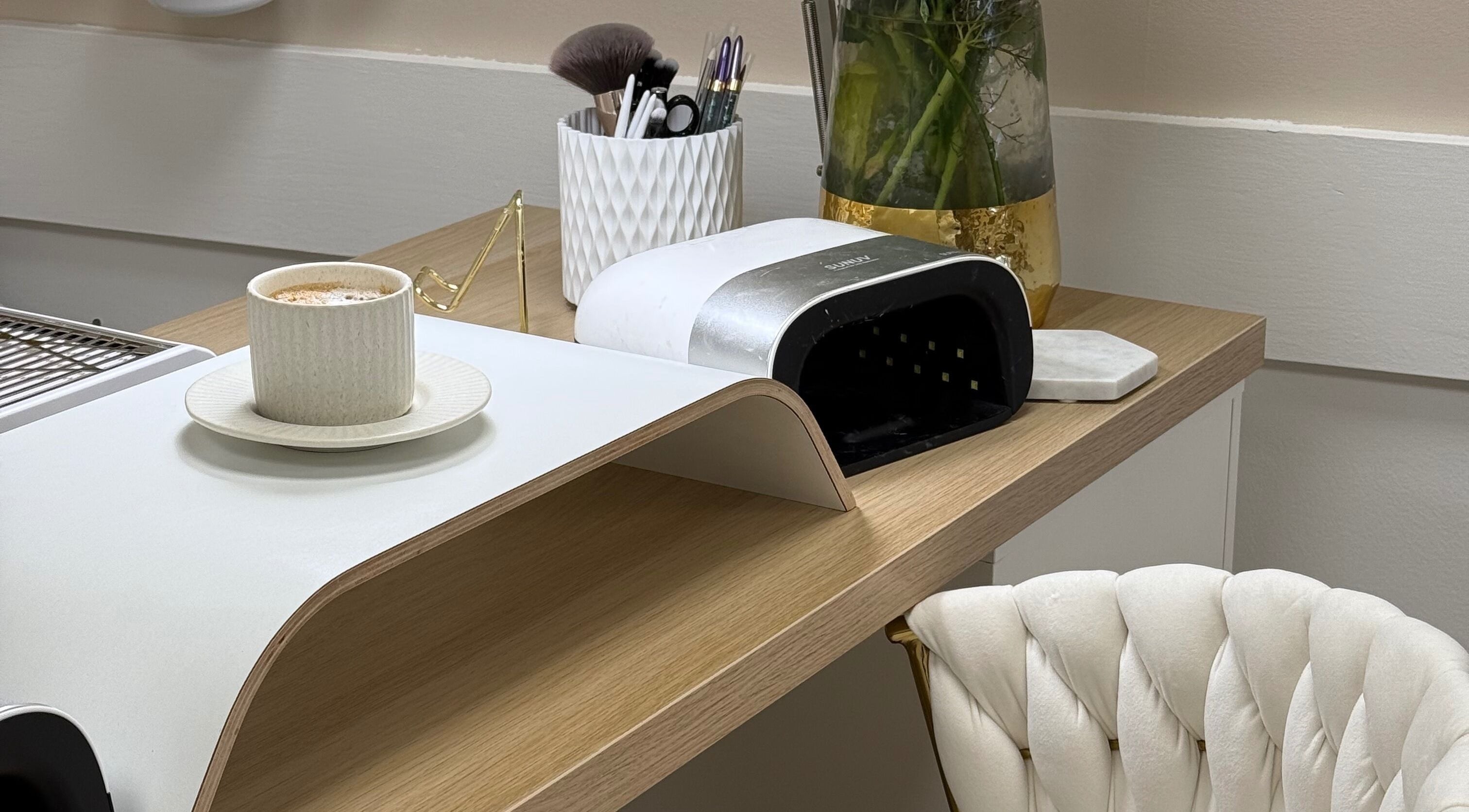 Relaxing manicure station at Olive Nails Studio, Kilmarnock, Scotland, GB with tools, chair, and coffee.