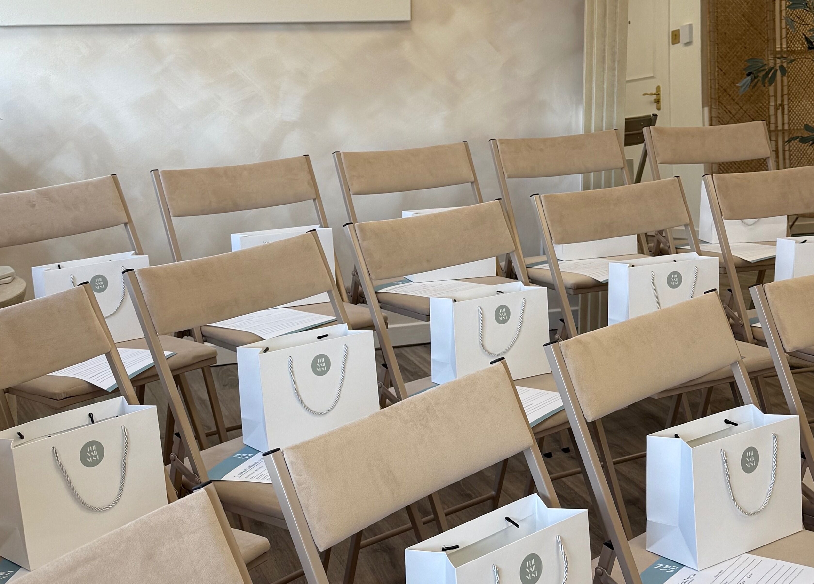 Chic seminar setup at Olive Nails Studio, Kilmarnock, Scotland, GB with beige chairs and gift bags.