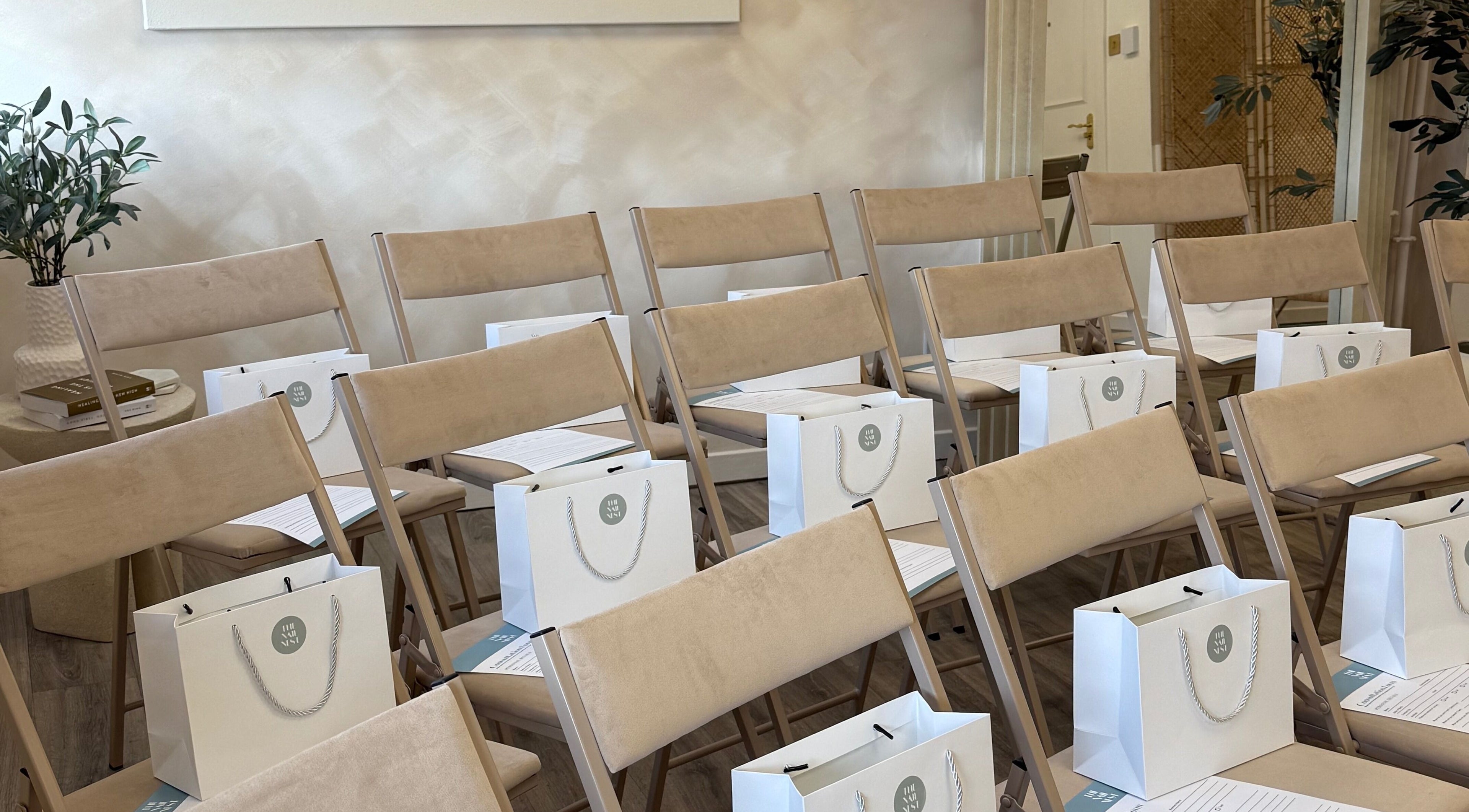 Chic seminar setup at Olive Nails Studio, Kilmarnock, Scotland, GB with beige chairs and gift bags.