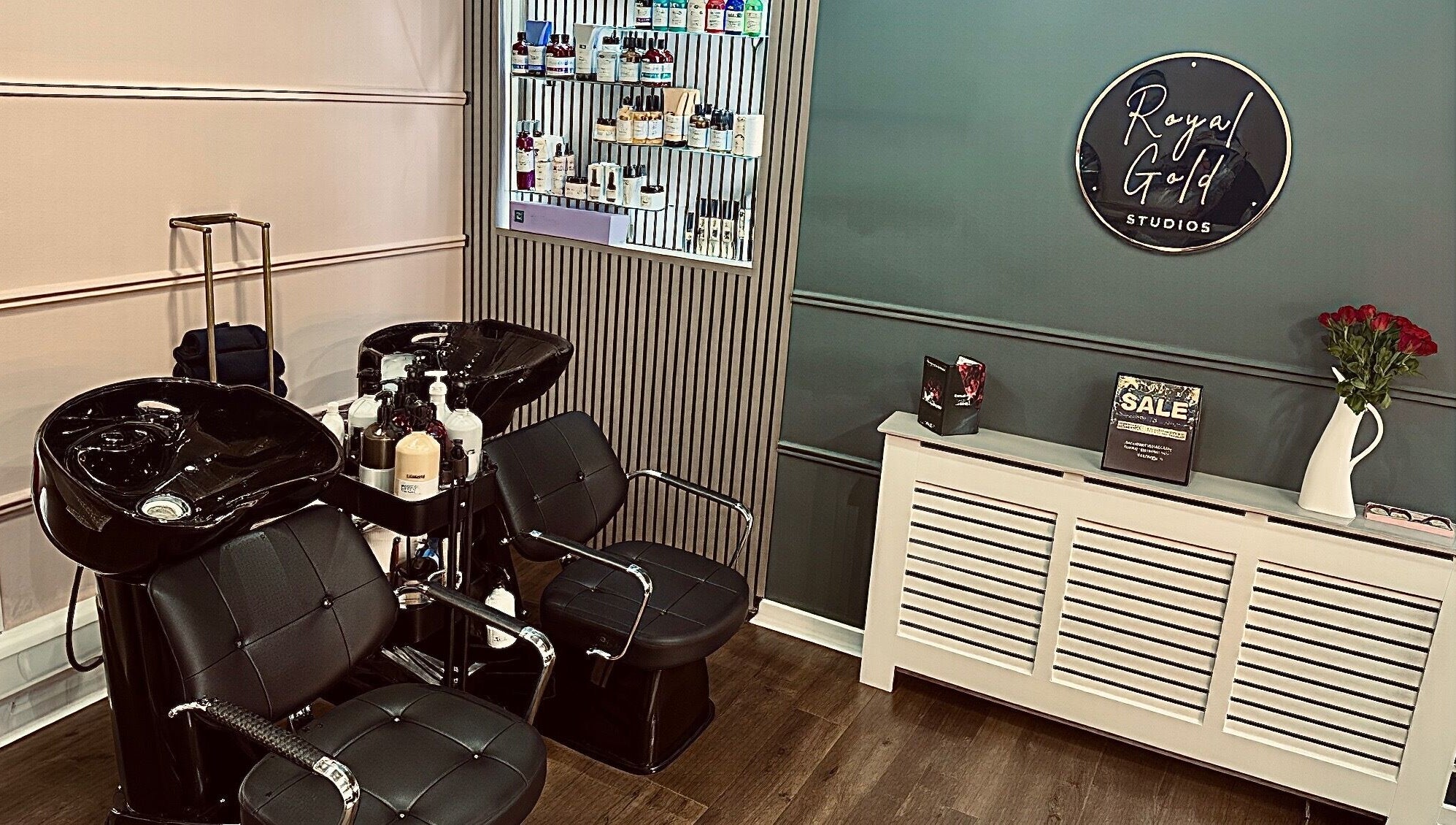 Chic salon space at Royal Gold Studios, Mullingar, County Westmeath, IE showcasing modern styling chairs and product wall.