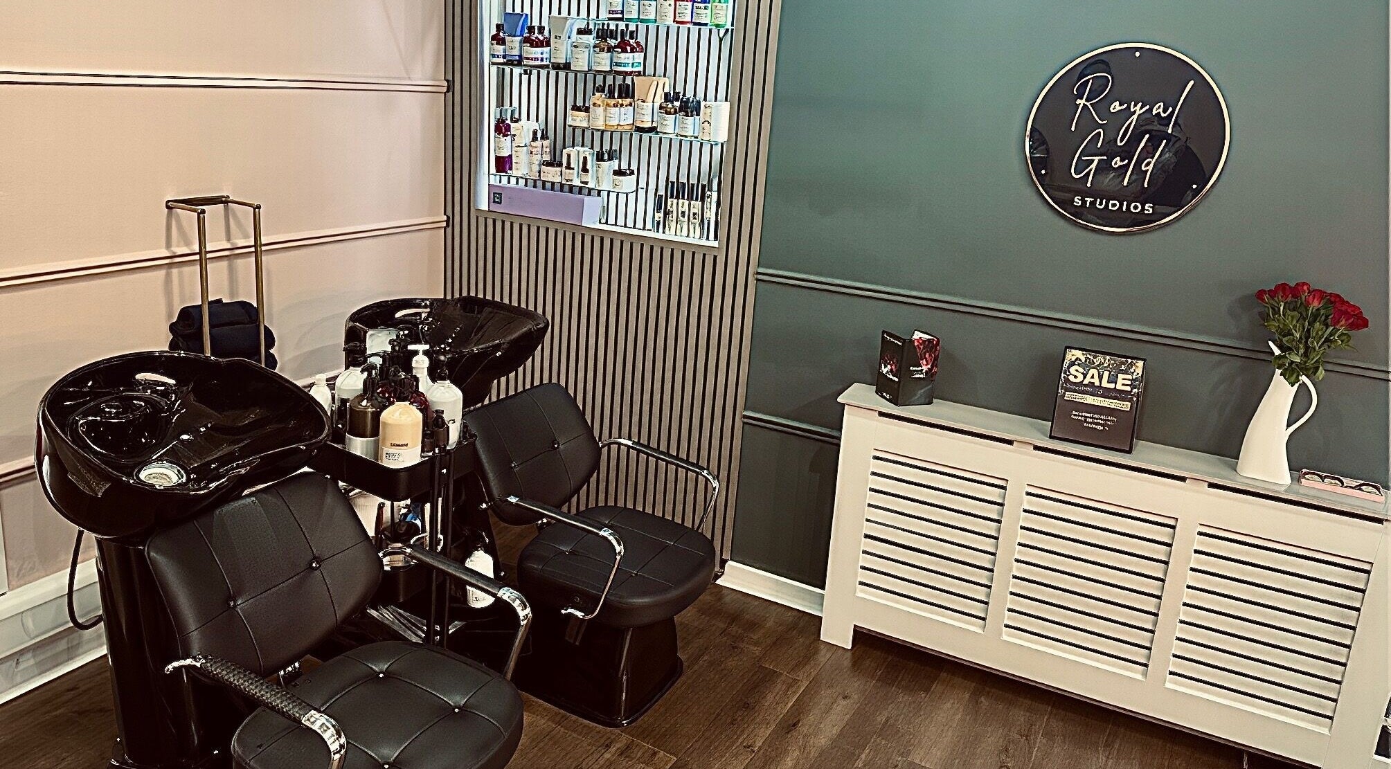 Chic salon space at Royal Gold Studios, Mullingar, County Westmeath, IE showcasing modern styling chairs and product wall.