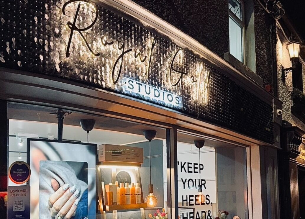 Illuminated facade of Royal Gold Studios, Mullingar, County Westmeath, IE at night showcasing beauty services.