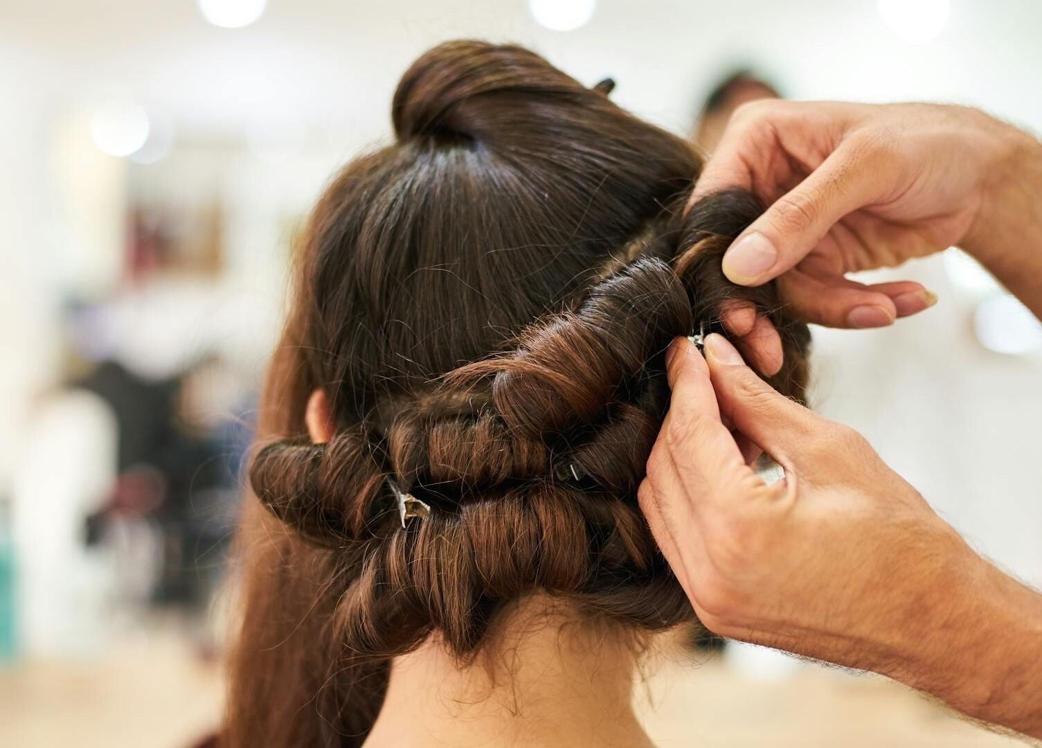 Hair stylist creating an elegant updo at Royal Gold Studios, Mullingar, County Westmeath, IE.