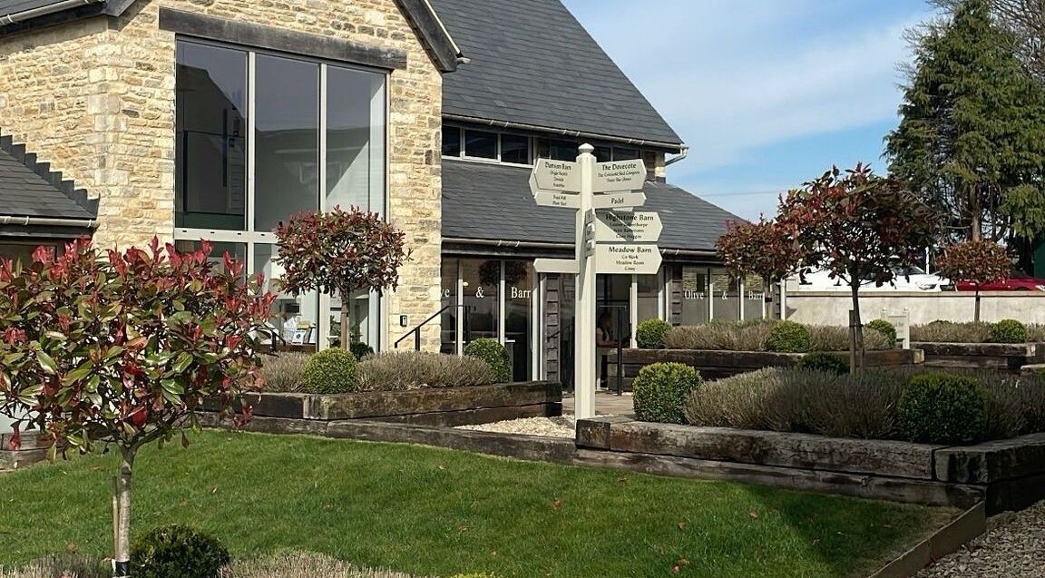 Moonlight Nails By Meg At Elkstone facade, showcasing lush gardens and classic stone architecture in Elkstone, England, GB.