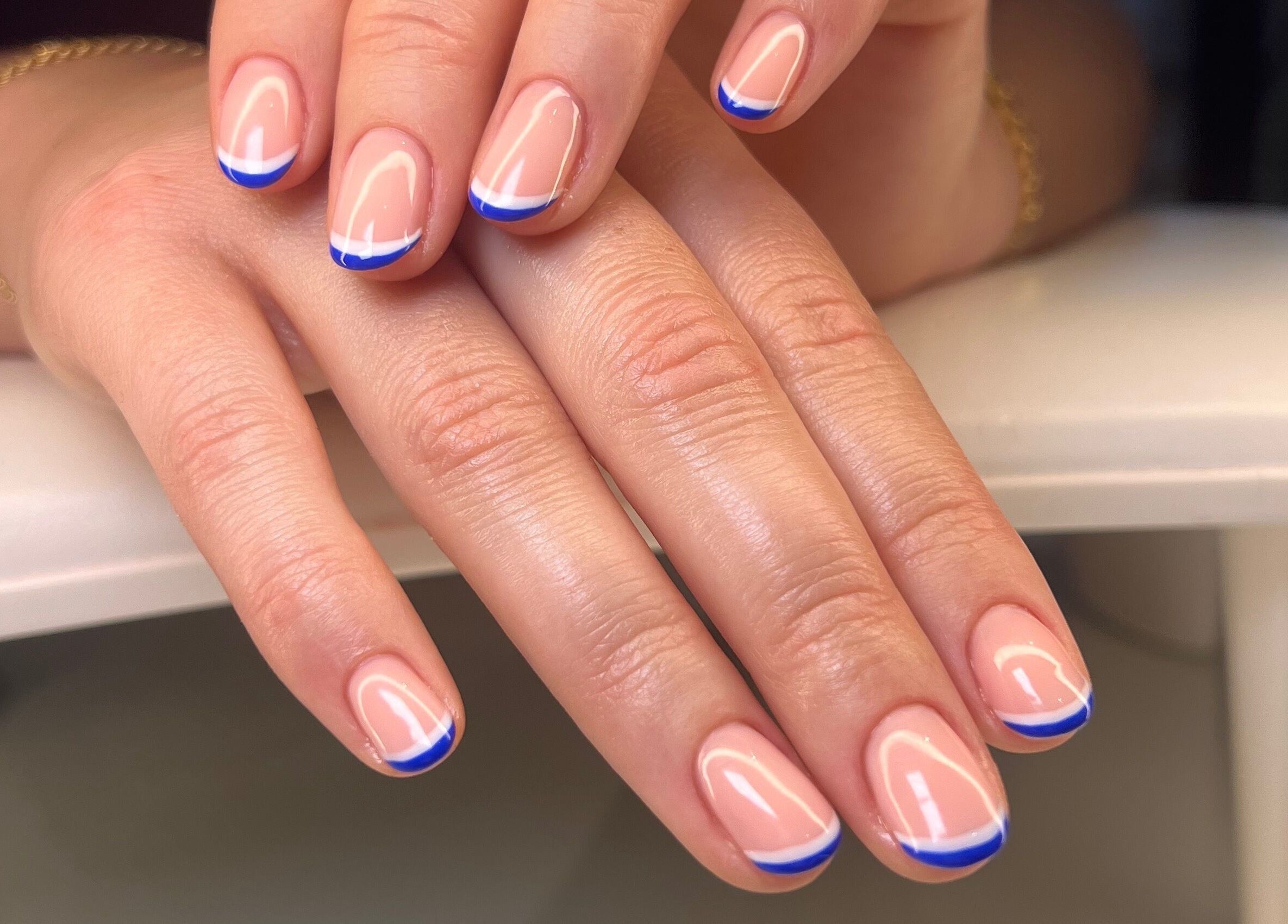 Elegant blue French manicure at Moonlight Nails By Meg At Elkstone, Elkstone, England, GB.