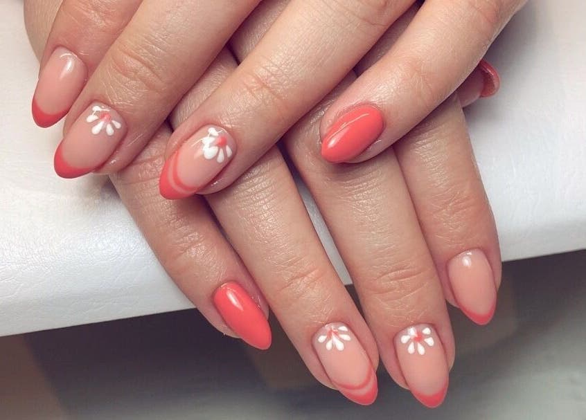 Elegant coral nails with floral designs at Moonlight Nails By Meg At Elkstone, England, GB.