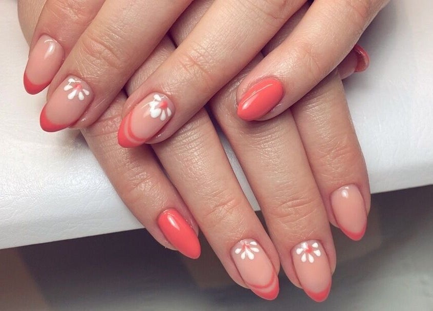 Elegant coral nails with floral designs at Moonlight Nails By Meg At Elkstone, England, GB.