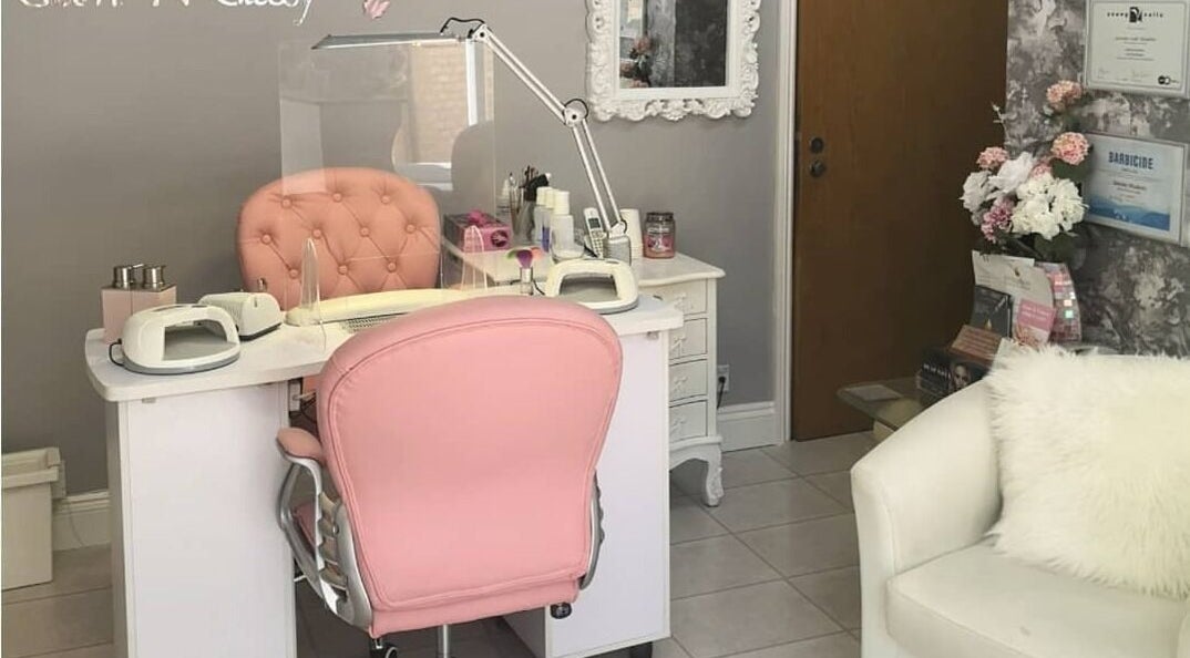 Sophisticated nail station at Glam N Glossy, South Woodham Ferrers, England, featuring a pink chair and elegant decor.
