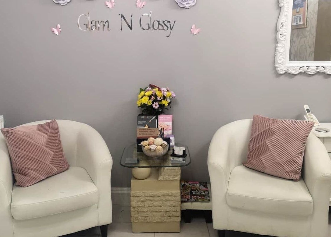 Cozy seating area at Glam N Glossy, South Woodham Ferrers, England, GB with elegant decor and flowers.