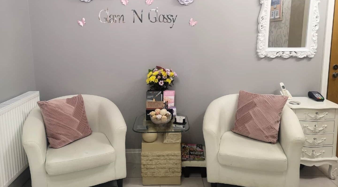 Cozy seating area at Glam N Glossy, South Woodham Ferrers, England, GB with elegant decor and flowers.