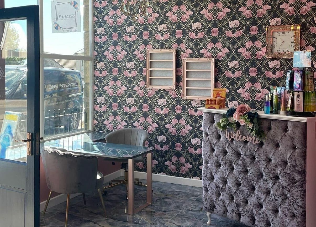 Elegant reception area at Princess Glam and Locks, Roche Cornwall, St Austell, England, GB with floral wallpaper.