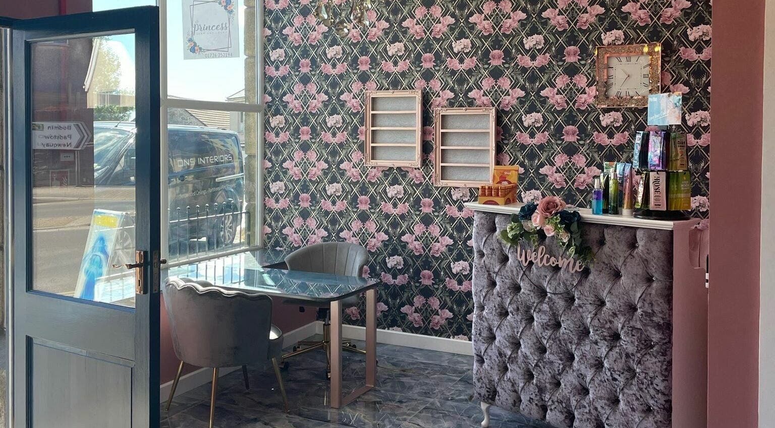 Elegant reception area at Princess Glam and Locks, Roche Cornwall, St Austell, England, GB with floral wallpaper.