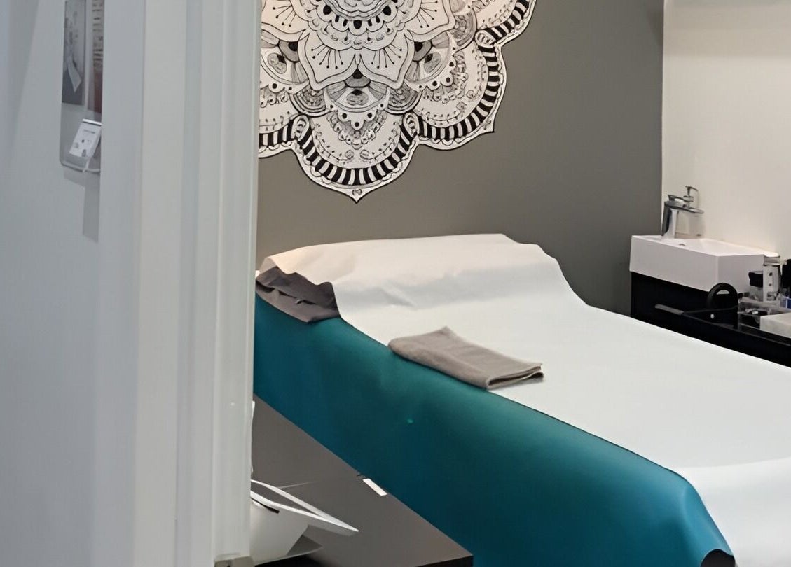 Calm treatment room at Liza's Skincare and Waxing Studio, Chicago, Illinois, US with a decorated wall.