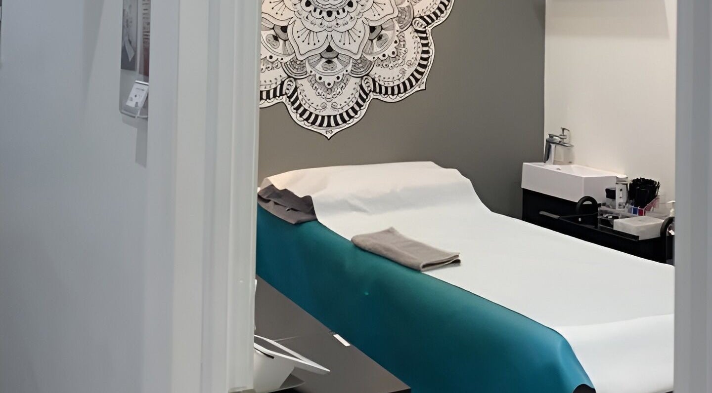 Calm treatment room at Liza's Skincare and Waxing Studio, Chicago, Illinois, US with a decorated wall.