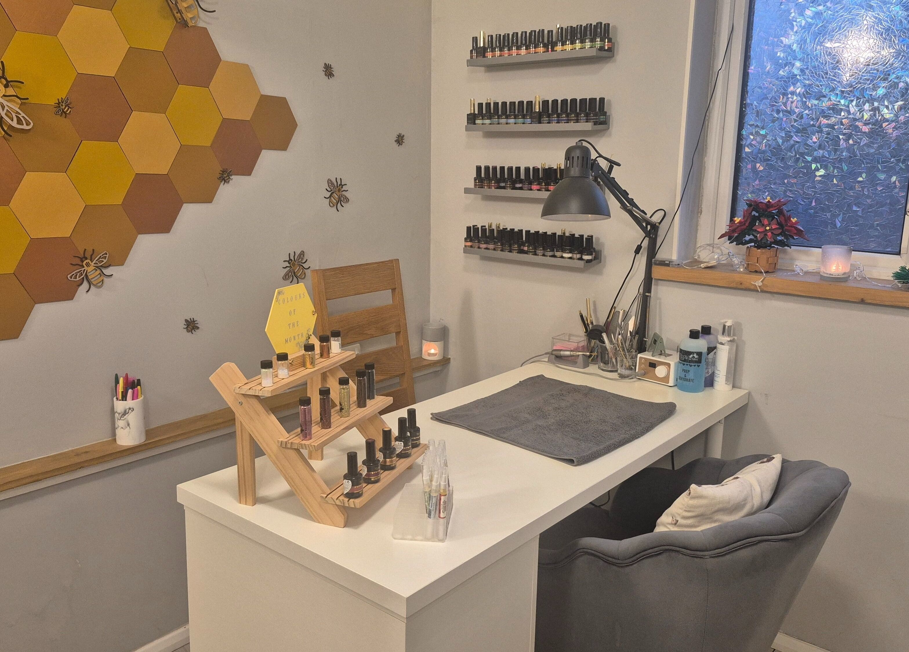 Bee-themed nail salon interior at CCB Nails and Beauty, Basingstoke, England, GB, displaying nail polish collection.