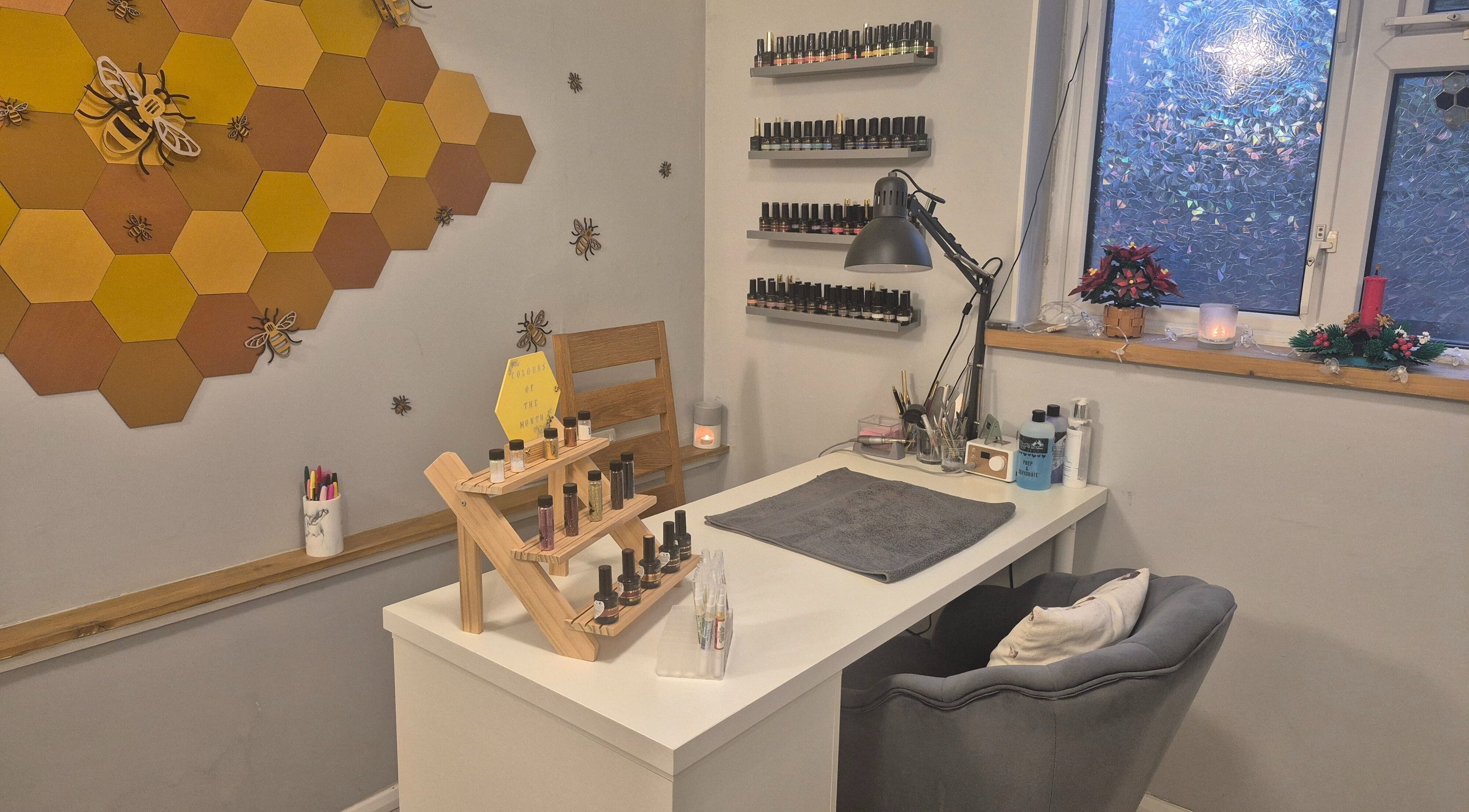 Bee-themed nail salon interior at CCB Nails and Beauty, Basingstoke, England, GB, displaying nail polish collection.