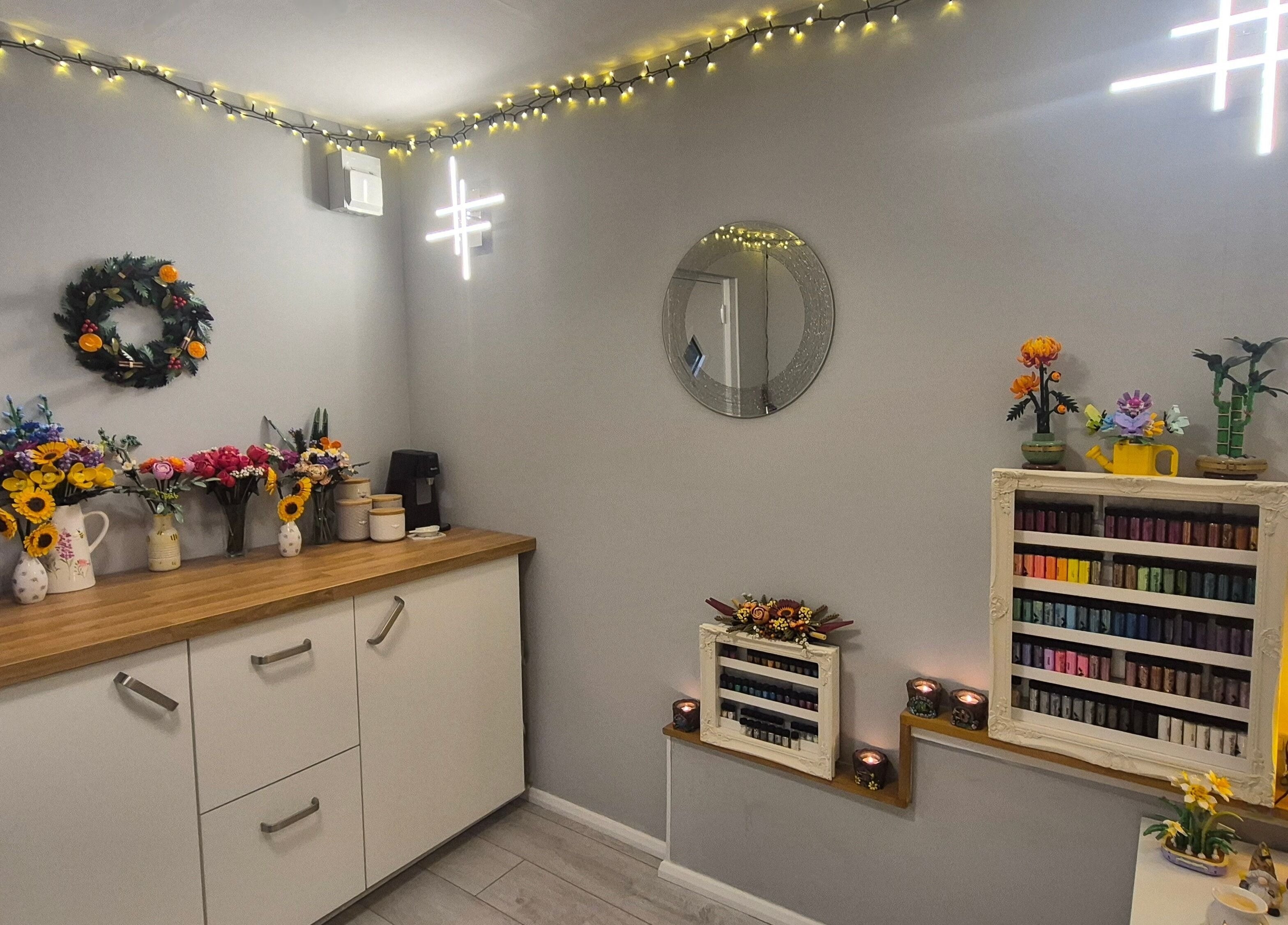 Inviting interior of CCB Nails and Beauty in Basingstoke, England, GB. Decor with flowers and nail polish displays.