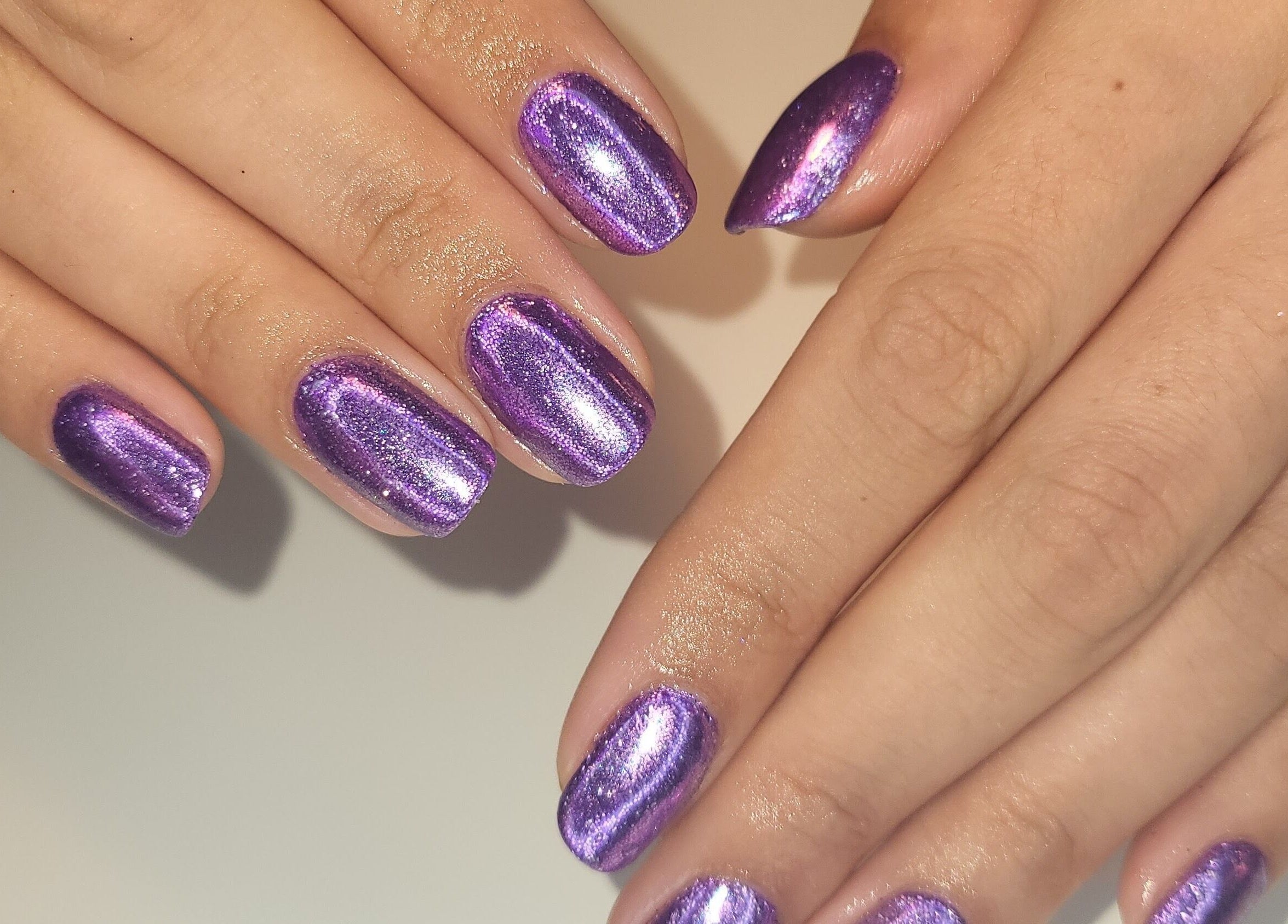 Shimmery purple manicure at CCB Nails and Beauty, Basingstoke, England, GB showcasing elegance.