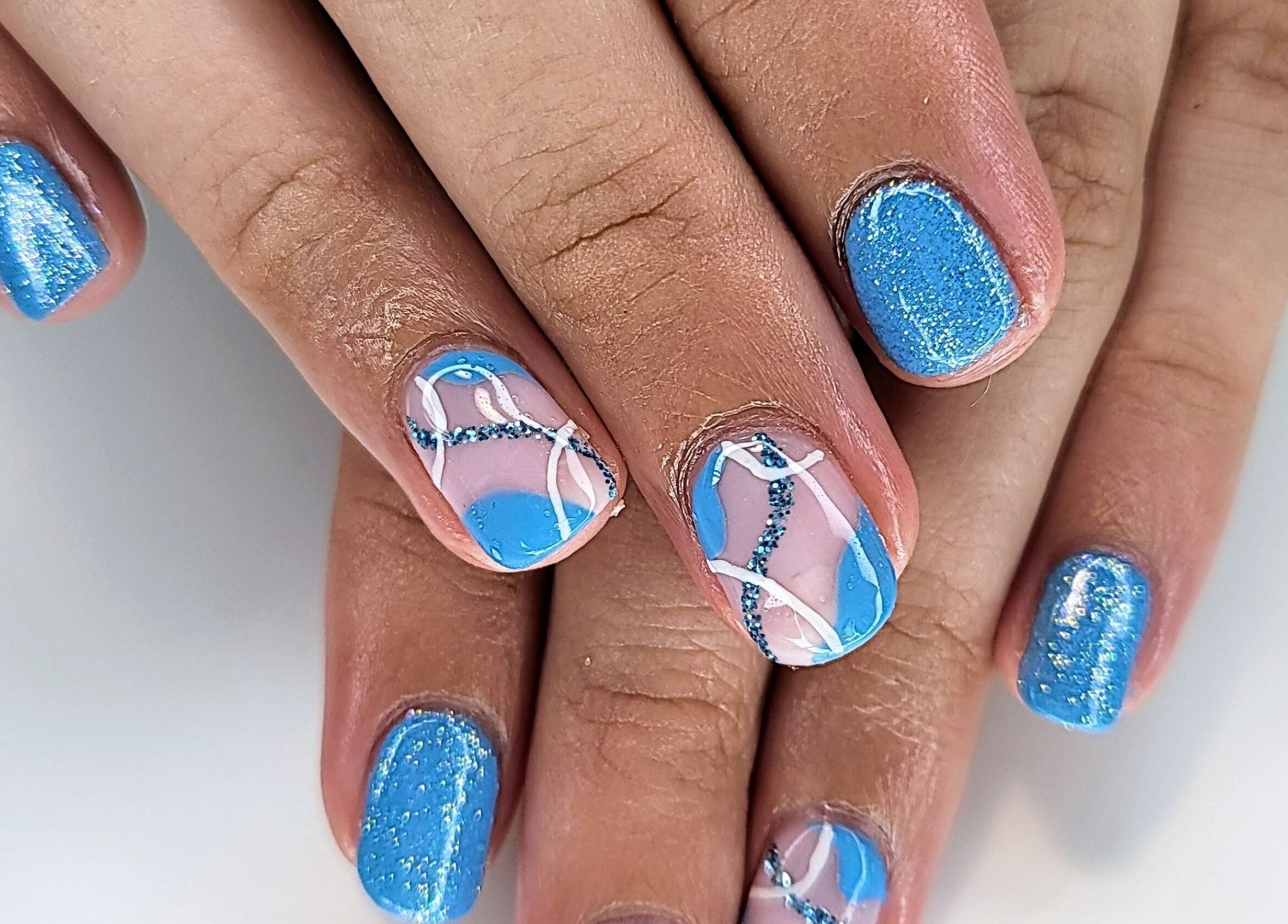 Blue and glitter nail art at CCB Nails and Beauty, Basingstoke, England, GB.
