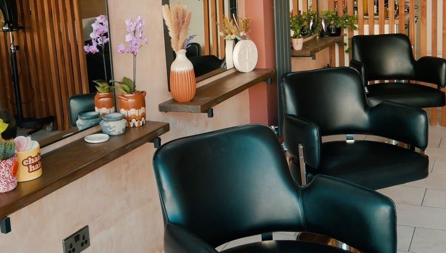 Modern salon chairs at Chaice Hair, Birmingham, England, GB, featuring chic, floral decor.