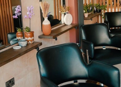 Modern salon chairs at Chaice Hair, Birmingham, England, GB, featuring chic, floral decor.