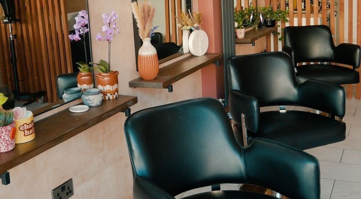 Modern salon chairs at Chaice Hair, Birmingham, England, GB, featuring chic, floral decor.