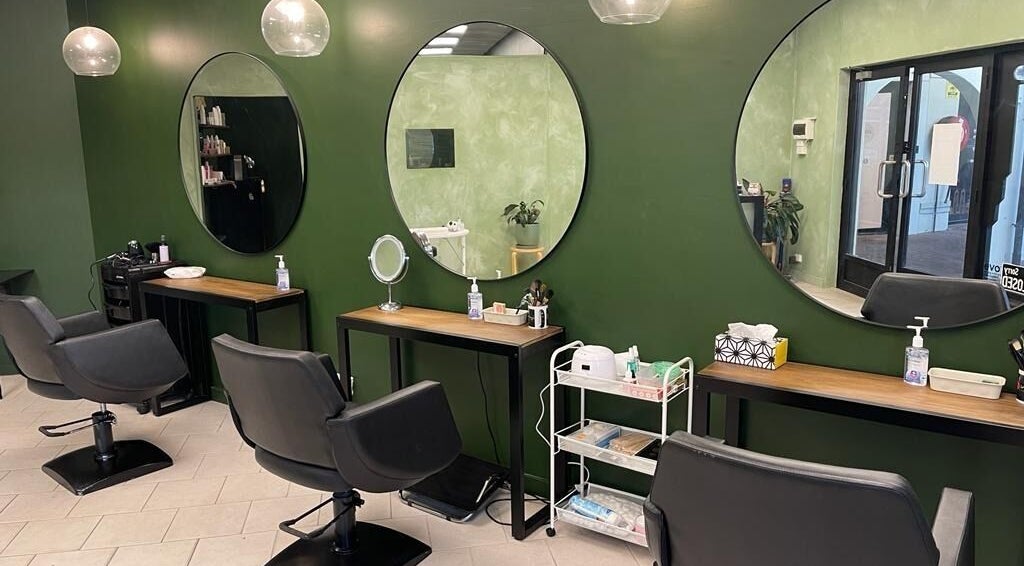 Modern styling stations at Amy's Hair Beauty and Nails, Brisbane, Queensland, AU with green walls and mirrors.