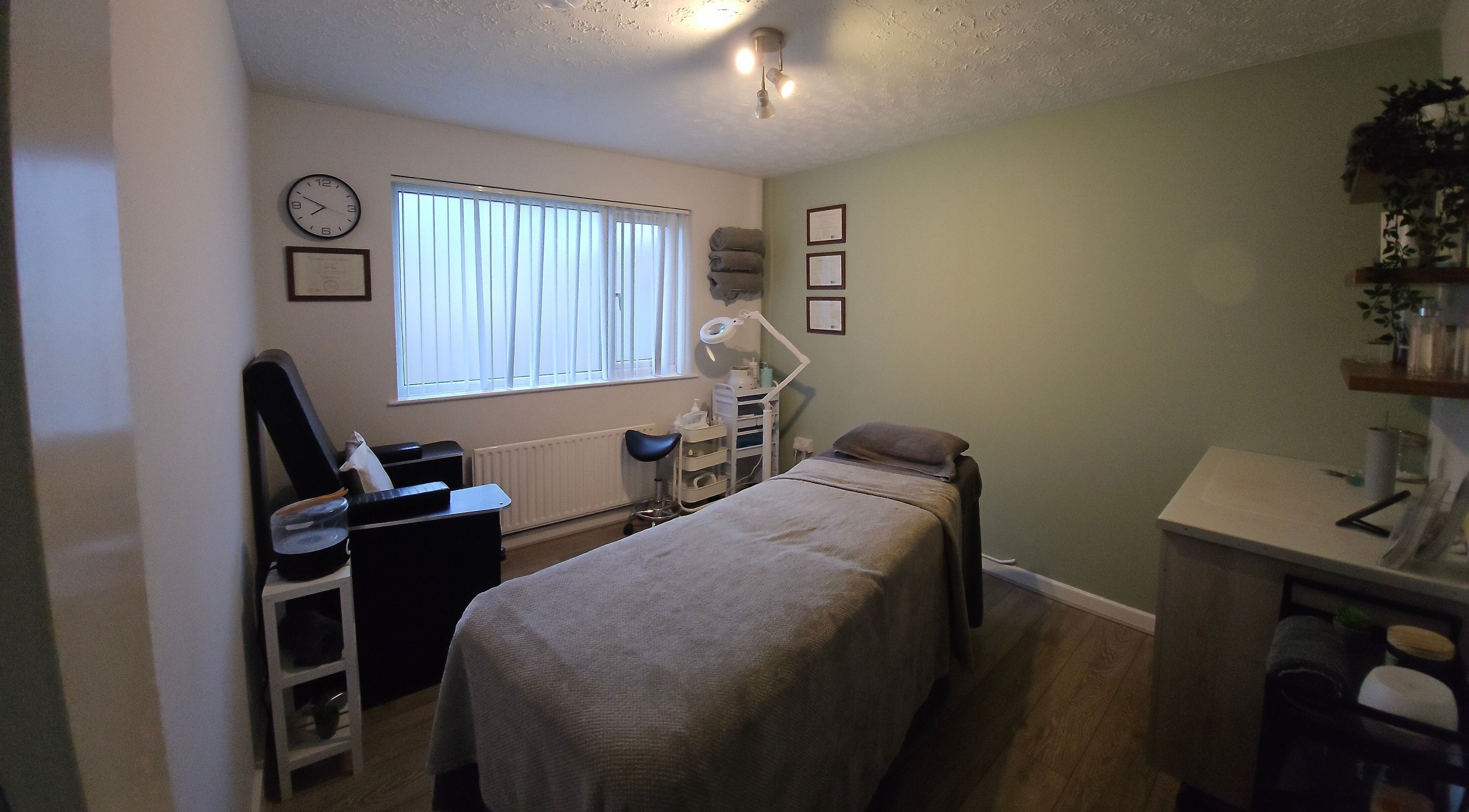 Calm treatment room at The Nail Gallery and Beauty, Bodmin, England, GB with a comfy bed and soothing decor.