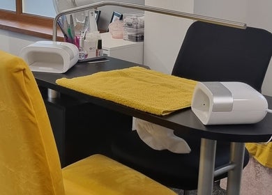 Nail workstation at The Nail Gallery and Beauty, Bodmin, England, GB, with yellow chair and tools.