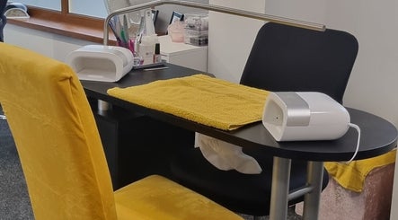 Nail workstation at The Nail Gallery and Beauty, Bodmin, England, GB, with yellow chair and tools.