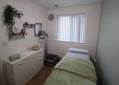 Relaxing treatment room at The Nail Gallery and Beauty, Bodmin, England, GB, with a massage bed and serene decor.