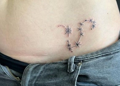 Elegant constellation tattoo on torso at Jane Doe Ink, Sandton, Gauteng, ZA.