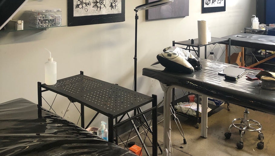 Tattoo station setup at Jane-Doe Ink Kramerville, Sandton, Gauteng, ZA, showcasing tools and workspace.