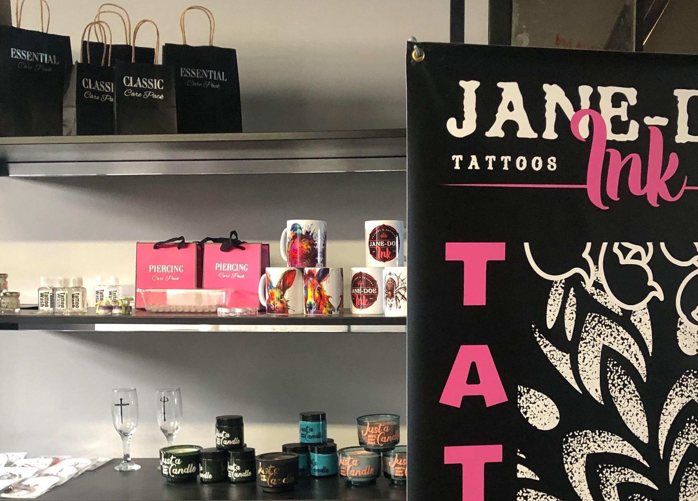 Merchandise display at Jane-Doe Ink Kramerville, Sandton, Gauteng, ZA featuring mugs and care packs.