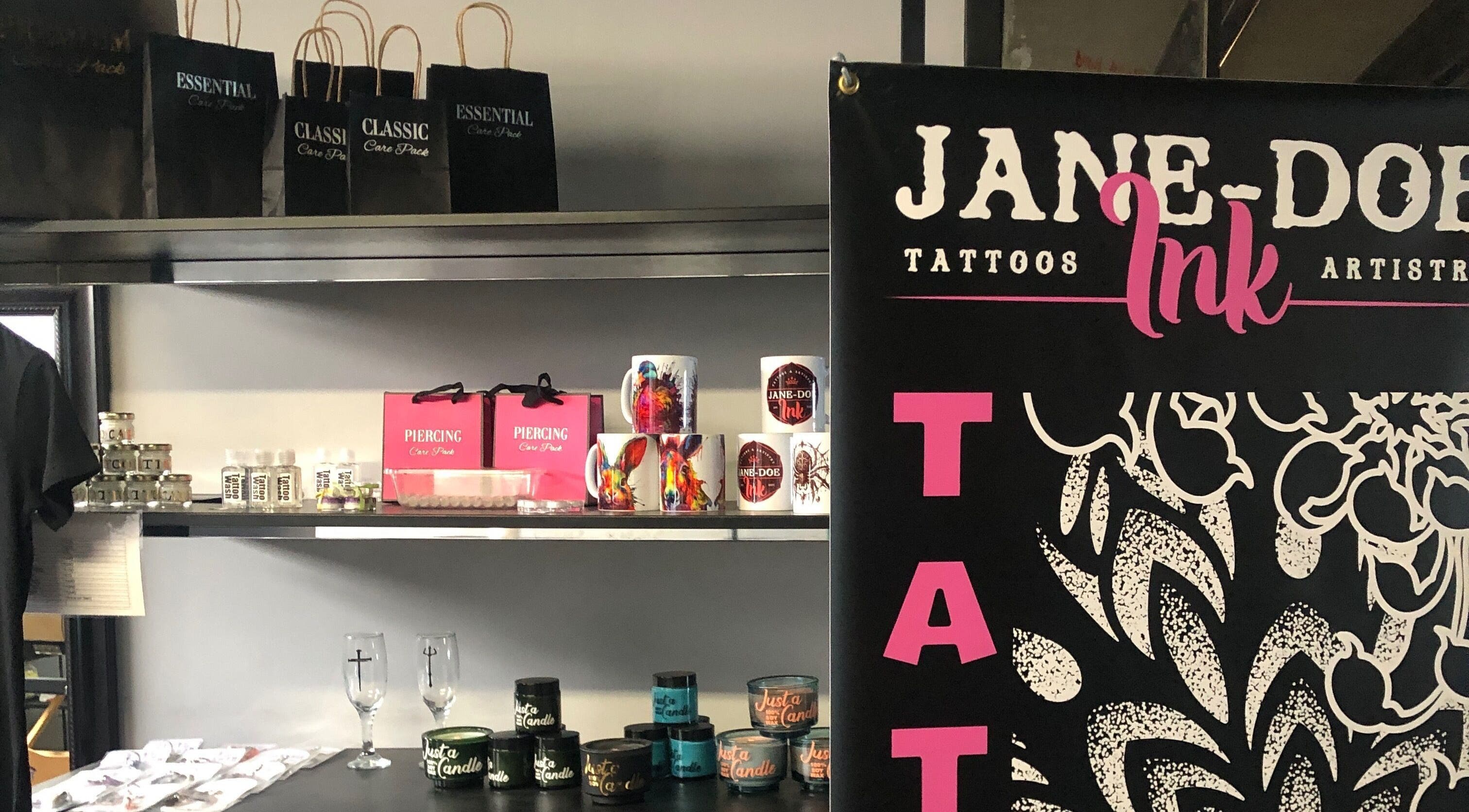 Merchandise display at Jane-Doe Ink Kramerville, Sandton, Gauteng, ZA featuring mugs and care packs.