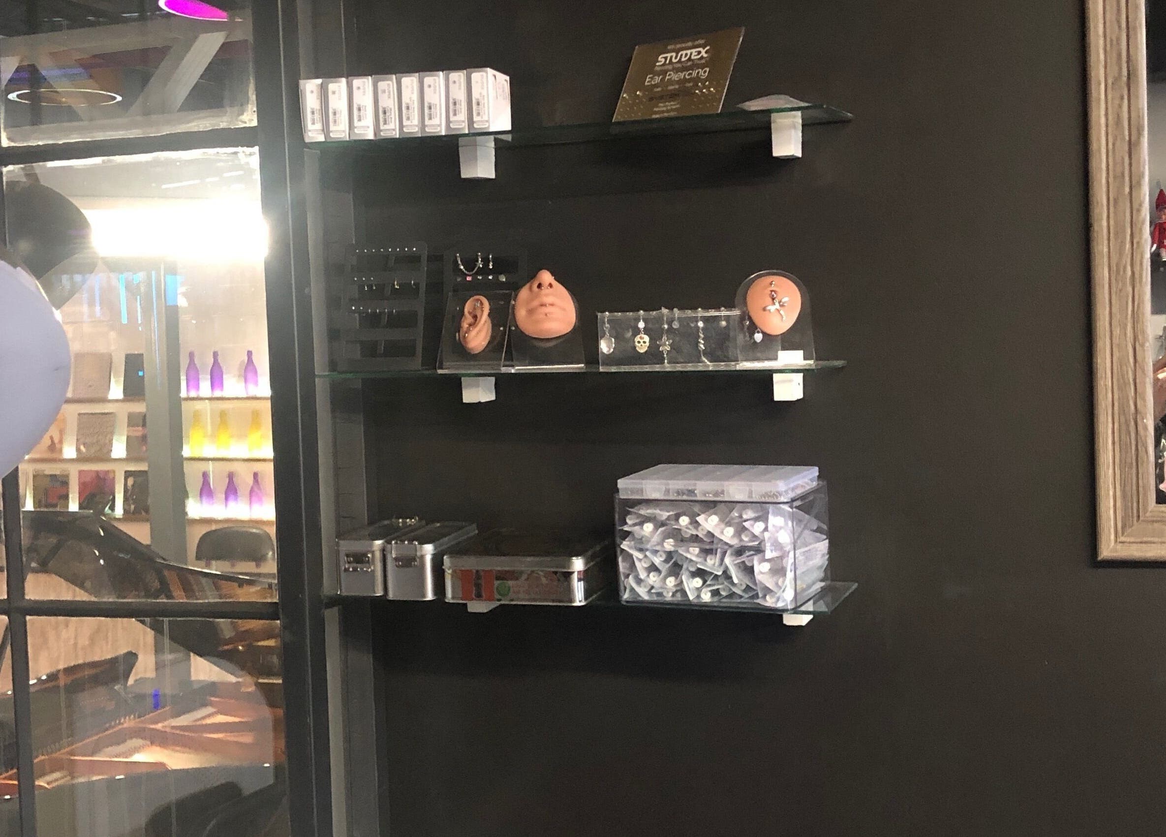 Interior shelf display at Jane-Doe Ink Kramerville, Sandton, Gauteng, ZA showcasing piercings and decor.