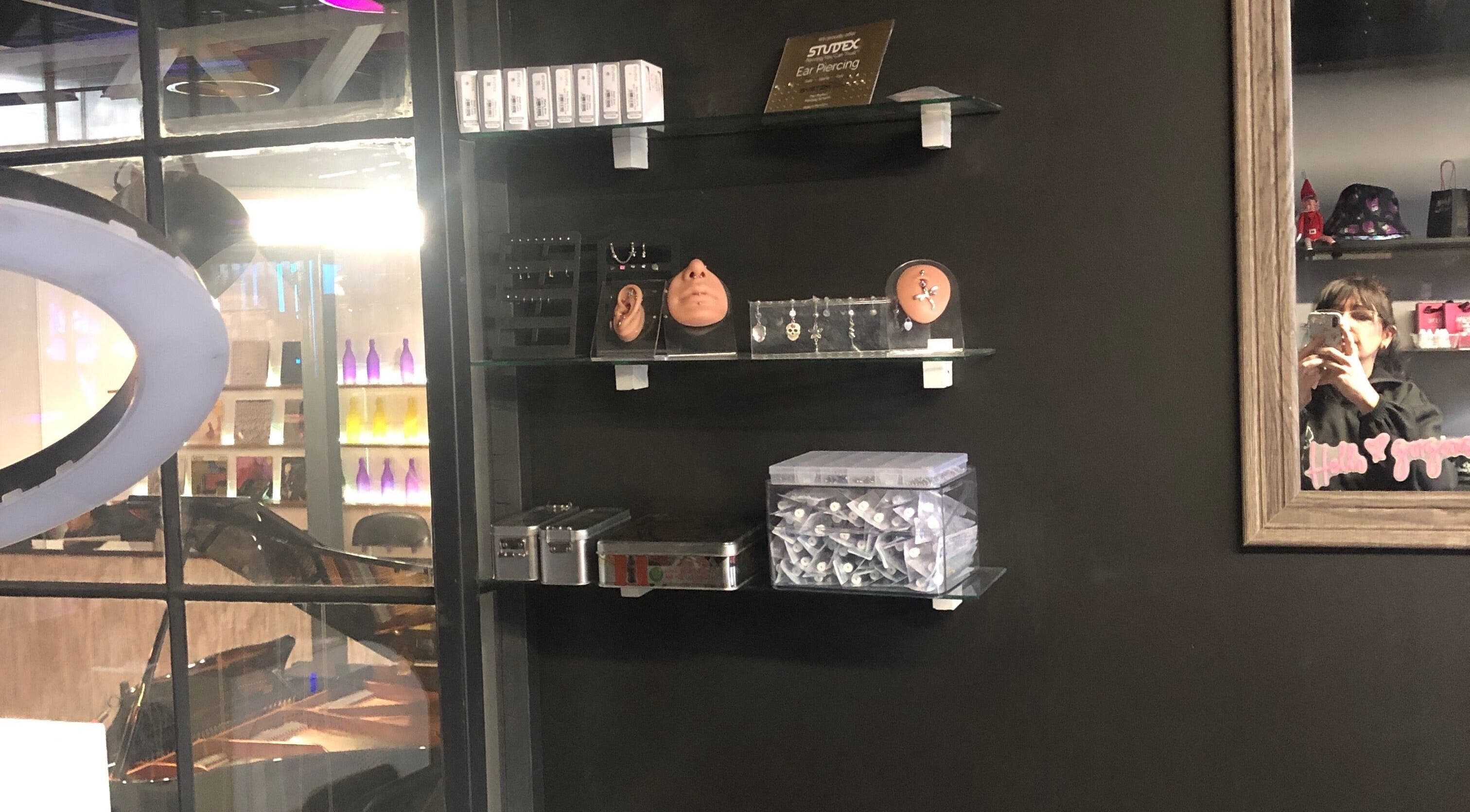 Interior shelf display at Jane-Doe Ink Kramerville, Sandton, Gauteng, ZA showcasing piercings and decor.