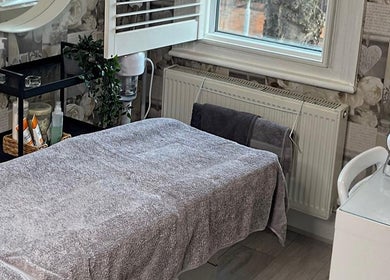 Tranquil treatment room at AJ Beauty Studio, Hucknall, England, GB with massage table and spa decor.