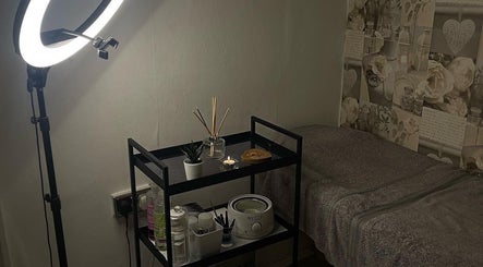 AJ Beauty Studio in Hucknall, England: stylish beauty treatment room with a ring light and organized supplies.