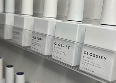 Glossify gel polish display at AJ Beauty Studio, Hucknall, England, GB, showcasing a range of polish bottles.
