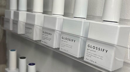 Glossify gel polish display at AJ Beauty Studio, Hucknall, England, GB, showcasing a range of polish bottles.
