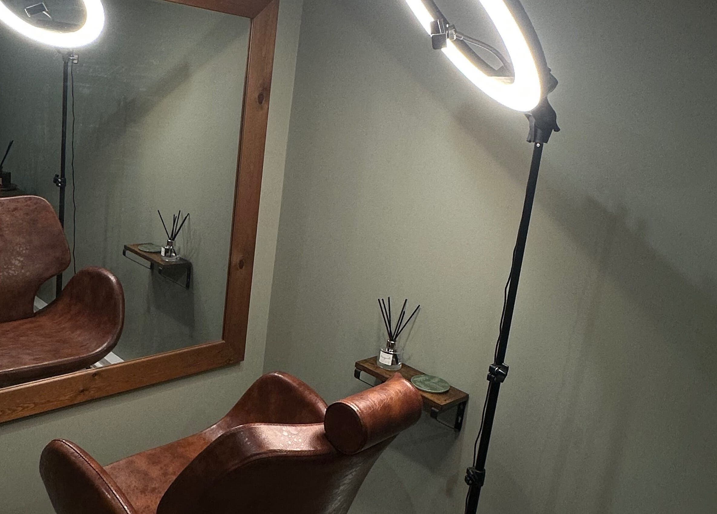 Stylish hair styling station at AJ Beauty Studio, Hucknall, England, GB, featuring a leather chair and mirror.
